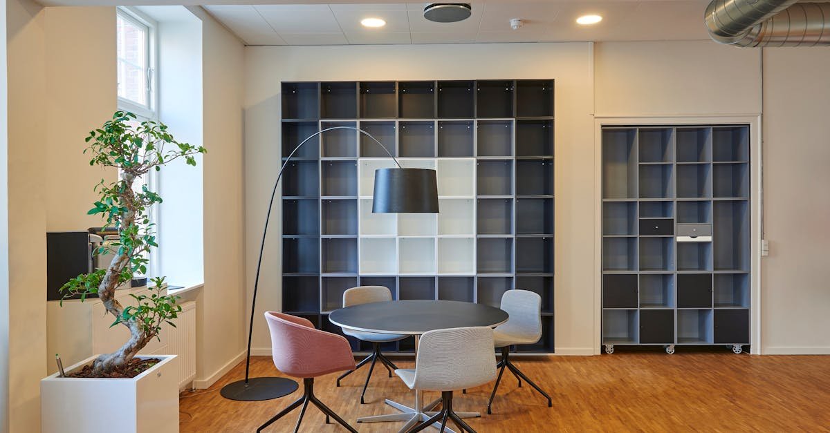 Bright and stylish office space with contemporary furniture and open shelving.